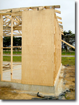 Photo of a sheet bracing in the frame of a house under construction.