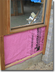 Photo of a timber window frame installed in a house under construction (external view).