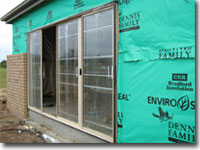 Photo of a window that has been installed in a house under construction.