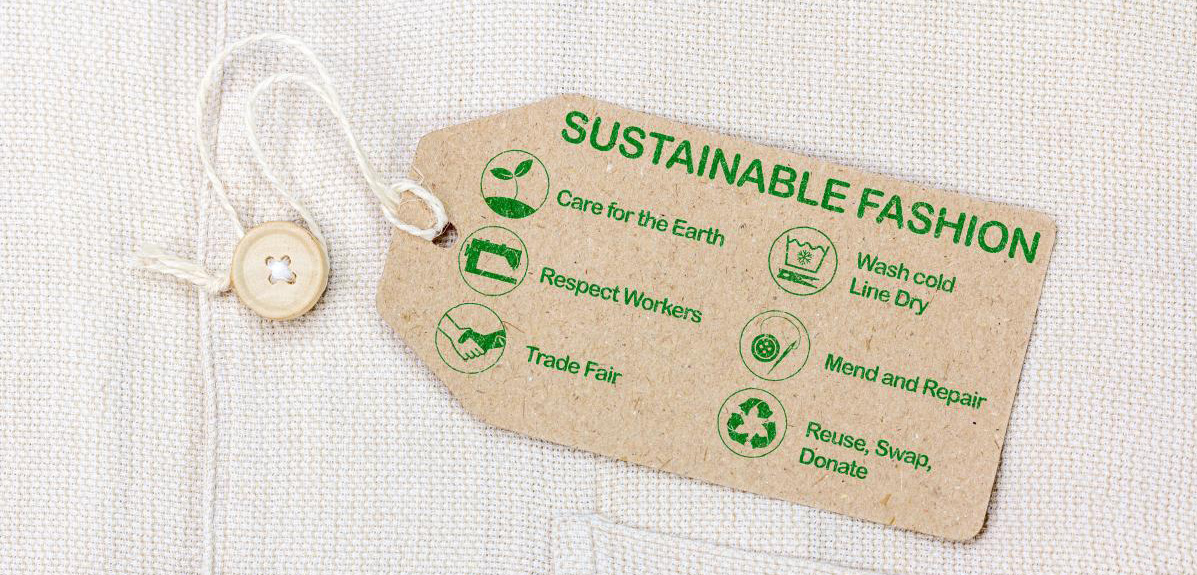 Brown paper label attached to a shirt, showing care instructions for sustainable fashion